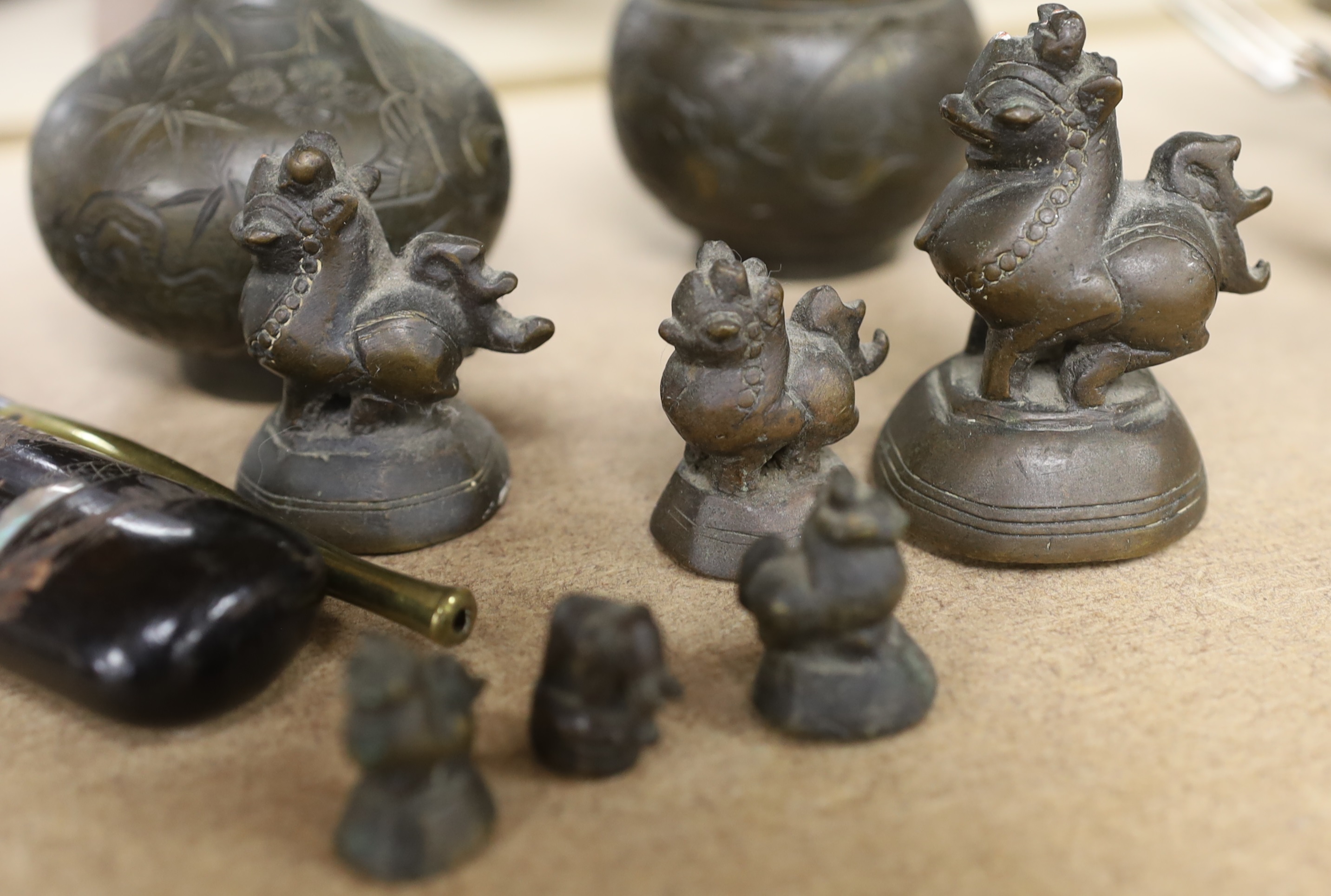 A set of Burmese bronze weights and a pair of bronze vases, 12cm